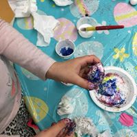 child making glitter art at preschool program at Lessard Playschool