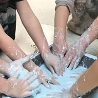 Kids playing in oobleck for Dr. Suess theme which is a mixture of water and cornstarch at Lessard Playschool